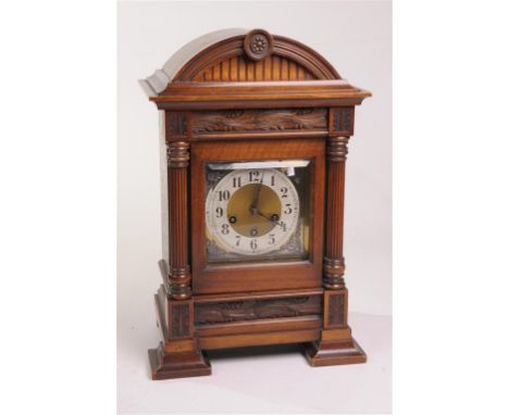 A bur walnut cased Junghans three train mantle clock, late 19th Century
With a 13cm silvered dial with Arabic numerals, flowe