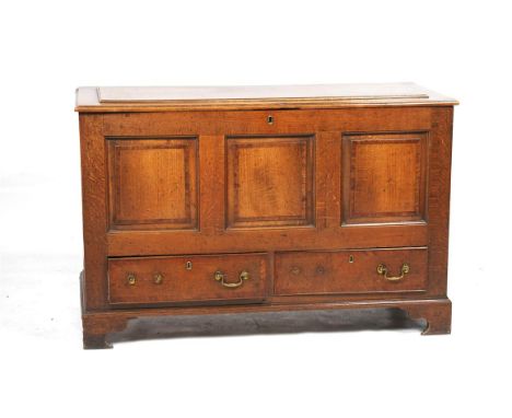 An 18th Century oak three panel mule chest
The rectangular hinged top with a raised panel with a crossbanded border enclosing