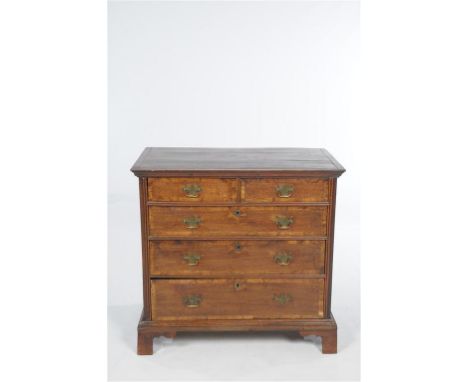 An 18th Century oak and walnut crossbanded chest of drawers
The rectangular top with a cavetto frieze above two short and thr