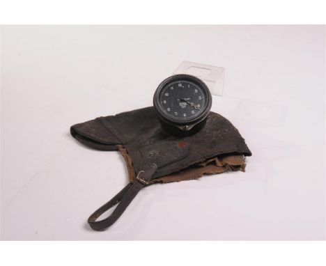 A vintage Smith's car clock
With a 7cm dial stamped H91260 with Arabic numerals, black painted brass case and a leather autom