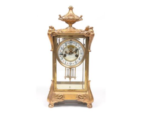 An attractive French four glass mantel clock
With a 10cm white dial with Arabic numerals with a visible escapement, the two t