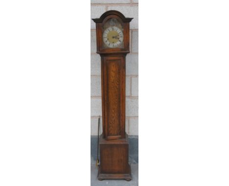 A 20th Century oak three train grandmother clock
With  a 20cm brass and silvered dial, Roman and Arabic numerals, mask spandr