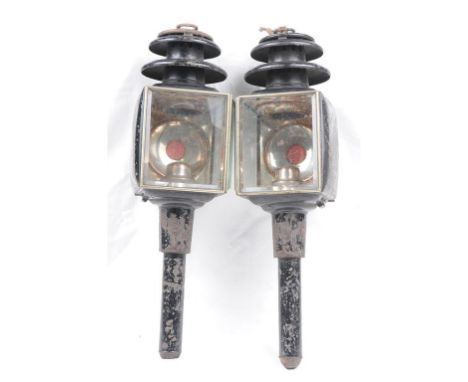 A pair of Victorian horse drawn trap lamps
Each of typical form with silver plated interiors, ruby reflector, black painted h