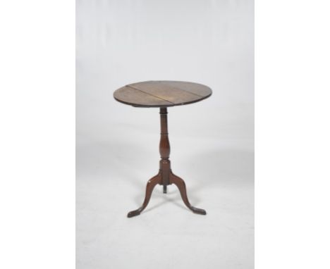 An early 19th Century oak lamp table
With a 52cm diameter three plank top raised on a  slender turned baluster shaft, triform