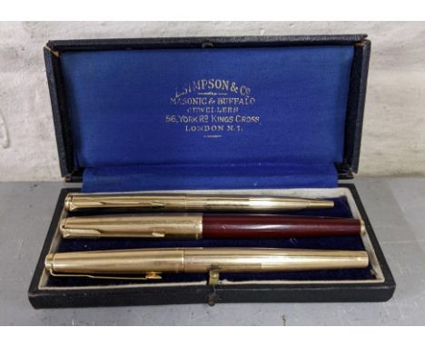 Three gold coloured Parker pens in a vintage box to include two fountain pens and a roller ball pen, Location:If there is no 