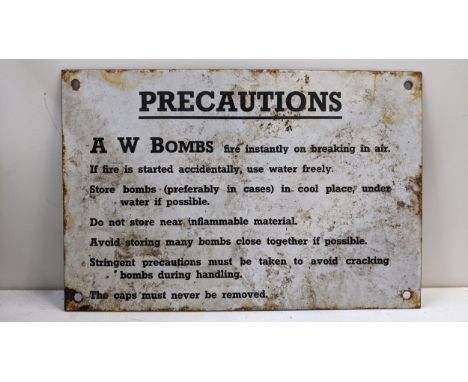 An enamel military sign for 'Precautions A W Bombs fire instantly on breaking in air' etc Location:If there is no condition r