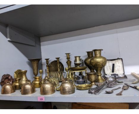 A selection of mixed metalware to include four bronze hand bells, various candlesticks, silver plate, Indian brass vases, and