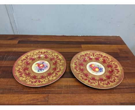 A pair of Royal Worcester plates, each decorated with a central panel of fruit, signed F Woods and other FreemanLocation:If t