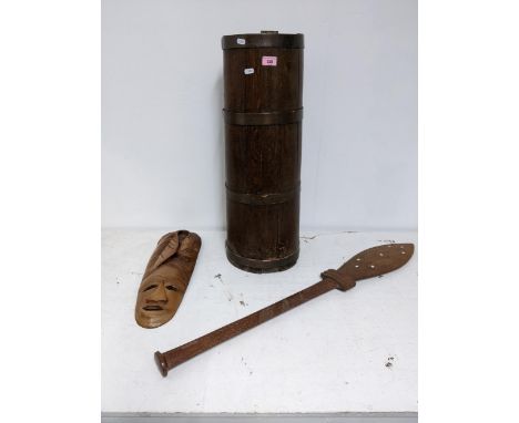 A coopered barrel stick stand, an Oceanic carved wooden paddle with inlaid mother of pearl and a carved wooden wall maskLocat