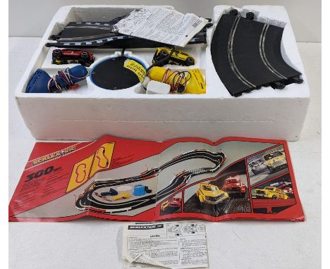 A Scalextric and track to include two Mini Clubman's 1275 GT's one red and the other yellow, in the original box. (Completene