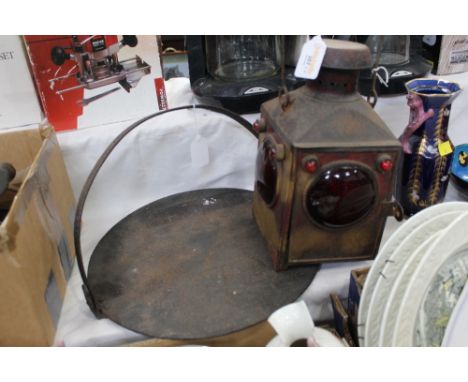 Skillet and a railway lantern with red lenses