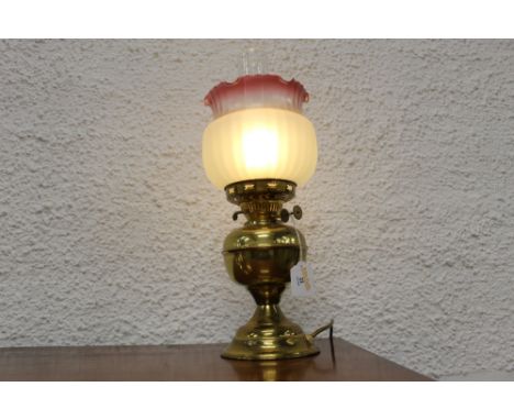 Decorative table lamp with shade and chimney in the form of an oil lamp converted to electricity