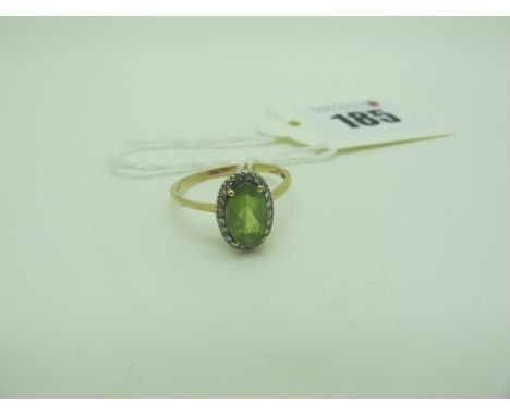 A 9ct Gold Diamond and Peridot Set Cluster Ring, oval claw four claw set, between plain shoulders (finger size S1/2) (2.1gram