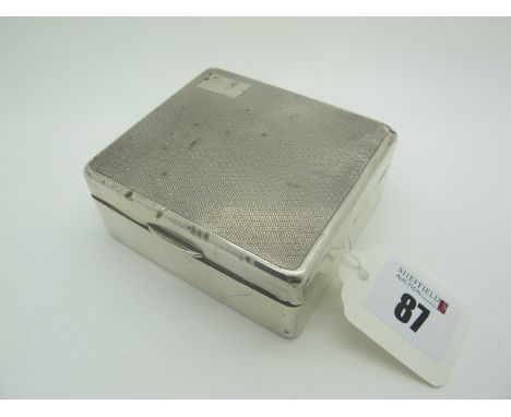 A Hallmarked Silver Cigarette Box, the hinged lid with engine turned decoration (damages), 8.6cm wide. 