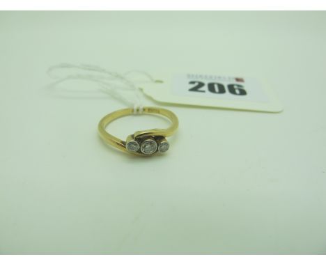 A Dainty Three Stone Diamond Ring, of crossover design, circular collet set, stamped "18ct" (finger size M). 