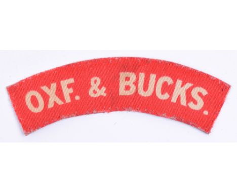 Scarce WW2 Ox & Bucks Light Infantry Printed Shoulder Title, white lettering on red backing. Uniform removed example. 