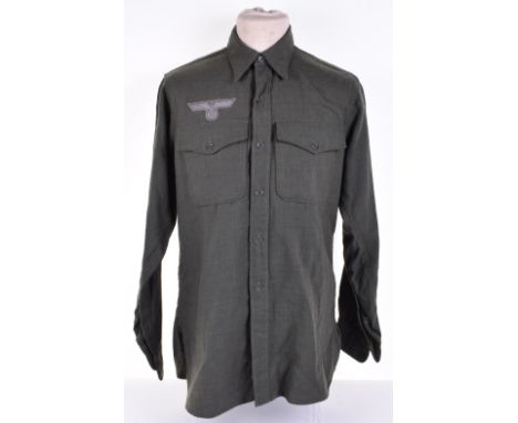 WW2 German Army Issue Shirt, of green wool with two breast pockets and button front. Machine embroidered breast eagle above p