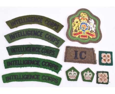 Cloth Insignia of the Intelligence Corps, consisting of 5x embroidered black lettering on green shoulder titles, WW2 black on
