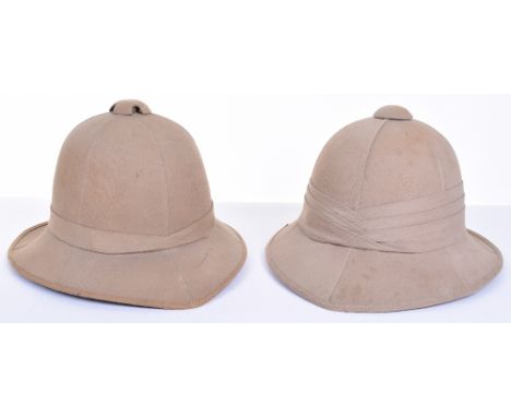 Two WW2 British Army Tropical Foreign Service / Sun Helmets, khaki cloth covered helmets with folded pagris. Both helmets hav