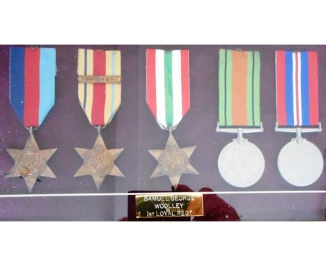 Framed set of WW II medals. 1939-45, Africa with 1st Army clasp, Italy Stars. Defence and War Medals; to Samuel George Wooley