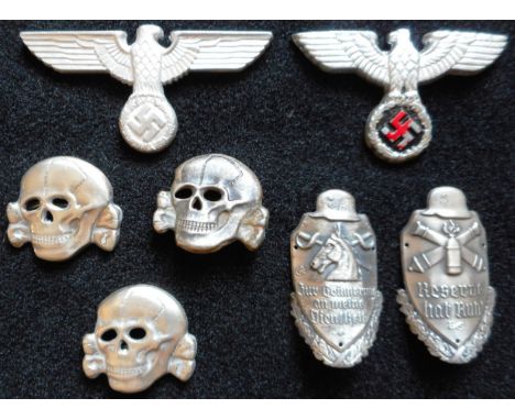 A small collection of alloy eagles, totenkopf and two stick badges 