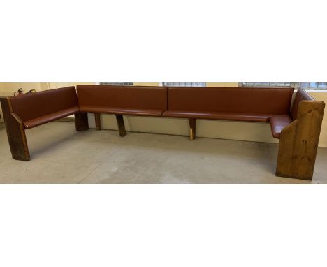 A large corner bench seat as taken from a local pub, originally made from antique pews. Covered in tan coloured studded leath