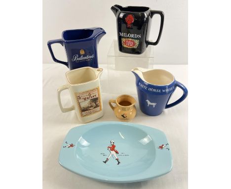 A collection of ceramic whiskey advertising water jugs together with an ashtray. To include Wade ceramics. 