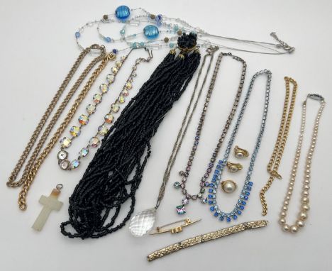 A collection of assorted vintage costume jewellery items. To include onyx cross pendant, diamante necklaces including aurora 