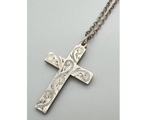 A vintage silver cross pendant with engraved decoration to front, on a 20" belcher chain with spring ring clasp. Silver marks