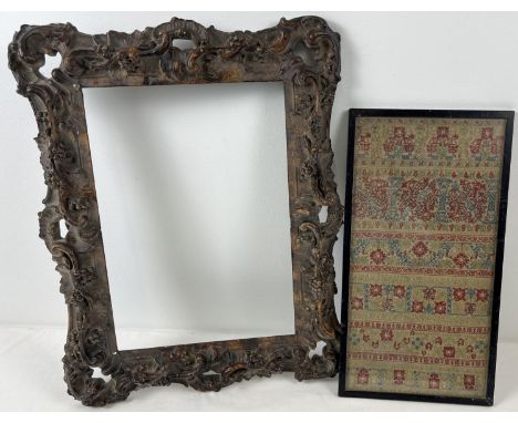 A framed and glazed antique embroidered panel depicting floral and column design. Together with an antique plaster picture fr