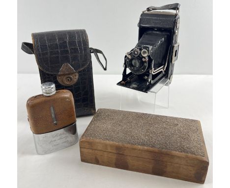 An antique Zeiss Ikon Ikonta 520/2 bellows camera with snakeskin effect leather case. Together with a vintage brown leather c