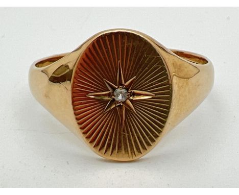 A men's vintage 9ct gold oval signet ring with central diamond and sun-ray detail to top. Full hallmarks to inside of band. S