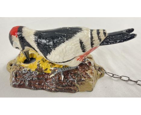 A decorative cast iron woodpecker door knocker with hand painted detail. Approx. 17cm long. 