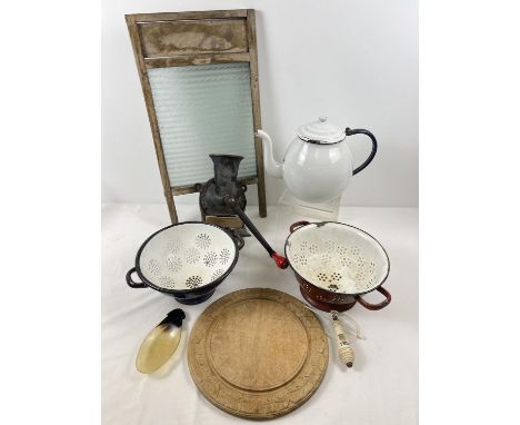 A collection of vintage kitchenalia. To include a large enamel teapot, colanders, carved bread board and a Sponge &amp; Co Lt