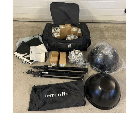 An Interfit professional photography light set up. In a large carry holdall. Lot includes light heads, bulbs, backdrops, trip