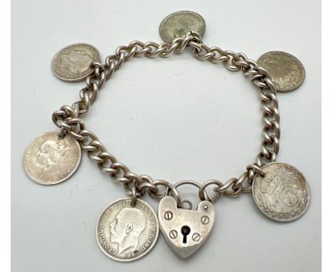 A vintage 8" silver charm bracelet with padlock and silver three pence charms. Coins comprise 5 x George V and 1 x Victoria. 