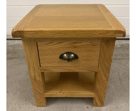 A modern light oak Sherbourne lamp table with single drawer and undershelf. Metal cup handle. Approx. 51cm tall x 45cm wide. 