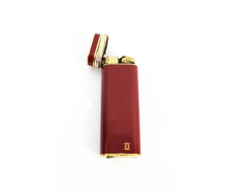 Must de Cartier, a gold-plated and red lacquer oblong pocket lighter ref G 18106. The hinged top with three-colour wire decor