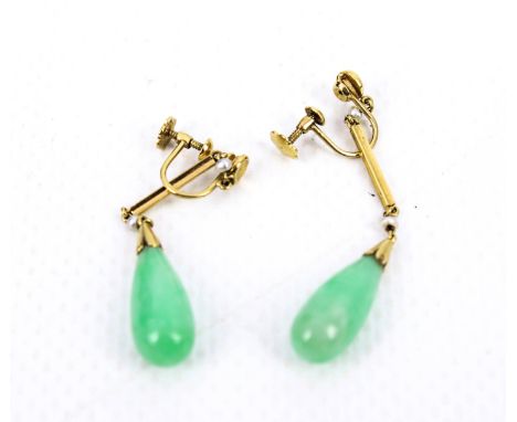 A pair of jadeite and seed-pearl pendent earrings, circa 1930. Each with a screw fitting stamped '15ct', suspending a fluted 
