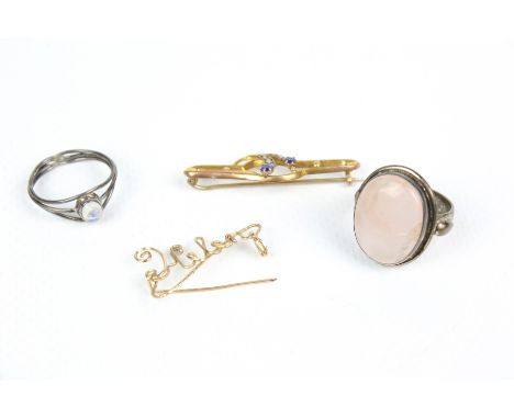 A small collection of jewellery. Including an early 20th century gold, blue-paste and half-pearl open floral brooch, stamped 