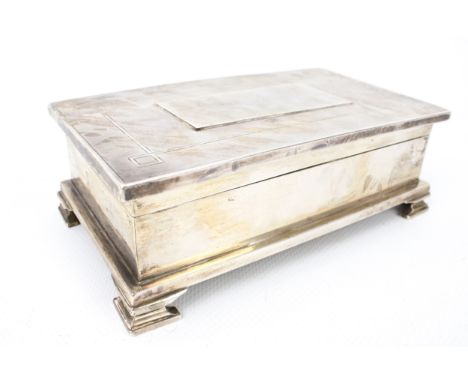 A silver rectangular 'treasury type' cigarette box. The hinged cover with a later centrally applied rectangular panel within 