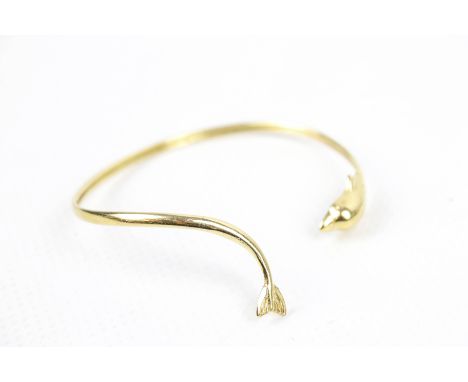 A vintage dolphin shaped torque bangle. Indistinctly stamped '585', 6.6g