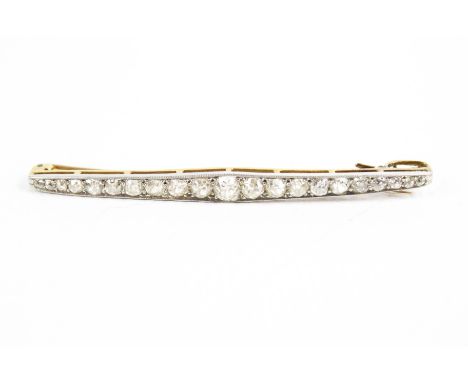 An early 20th century old-cut diamond line brooch. The 21 graduated old-cut stones grain set in platinum-flashed gold, the la