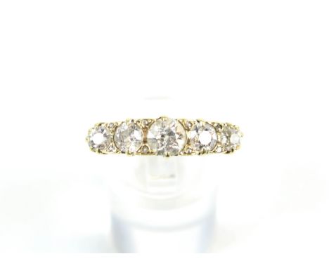 An early 20th century gold and diamond five-stone carved half-hoop ring. The graduated old-cut stones, approx. 1.70cts total,