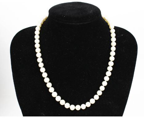 A cultured-freshwater-pearl single row necklace. The beads measure approx. 7.3mm-7.9mm diameter knotted on a large bolt-ring 