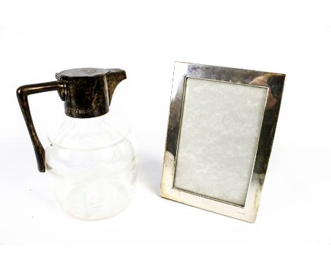 A late Victorian silver mounted clear cut glass claret jug and a photograph frame. The mallet shaped body of the jug with a c