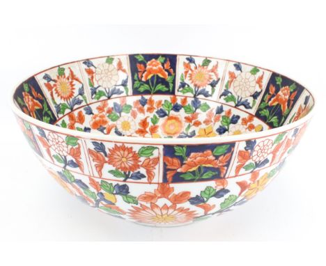 A 20th century Chinese ceramic punch bowl. The interior and exterior rims painted with multiple white and blue panels, each f