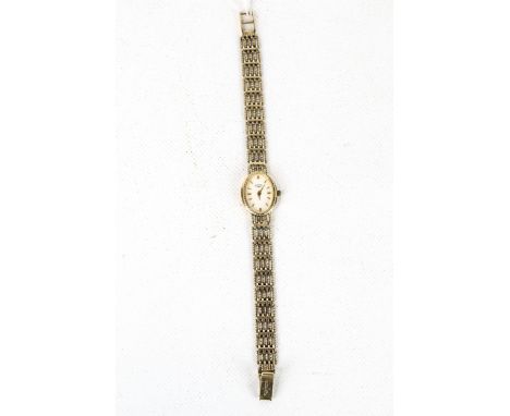 Rotary, a vintage lady's 9ct gold oval bracelet watch, circa 1996. The light-cream dial with gilt baton indicators and taperi