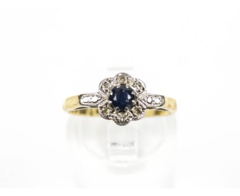 An early 20th century gold, sapphire and diamond cluster ring, circa 1930. Stamped '18ct & Plat' Condition Report: size K 1/4