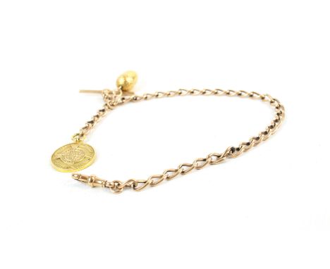 An early 20th century 9ct rose gold curb link watch chain. Each link stamped '9' and '.375', with a dog clip and a T-bar term